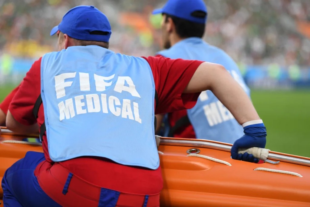 FIFA medical staff carrying a stretcher on the pitch